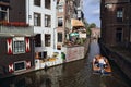 People in small boat in Amsterdam canal in Holland Royalty Free Stock Photo