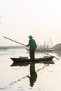 People with small boat on Van Long pond, Ninh Binh province, Vietnam