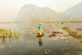 People with small boat on Van Long pond, Ninh Binh province, Vietnam Royalty Free Stock Photo