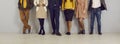 People in different smart casual clothes standing in office, low section shot of legs