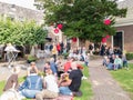 People with snacks and drinks on street food festival in histor