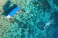 The people are snorkeling near the famous place on Gili Meno Island, Indonesia. Aerial view. Underwater tourism in the ocean. Gili