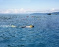 People snorkeling in open blue sea