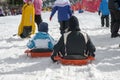 Wintertime: time to have fun in a ski resort. Snow, mountain, tobogganing. Royalty Free Stock Photo