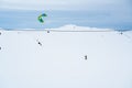 People Snowkiting on a frozen snowy mountain plain on a cold winters day. Royalty Free Stock Photo