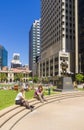 People soaking up the sun and Brisbane skyline