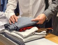 People Sorting and Folding Clothes in Retail Store Royalty Free Stock Photo