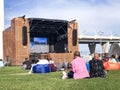 People, spectators watching a movie in a public street open air cinema movie