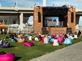 People, spectators watching a movie in a public street open air cinema movie