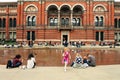 People spending their sunday afternoon in the courtyard at the Victoria and Albert Museum in London