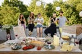 People spending time together, sitting separately in smart phones at party outdoors Royalty Free Stock Photo