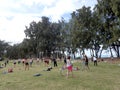 People spin hula hoops during outdoor hooping class