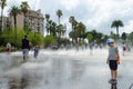 People are in splashes of fountain in gardens of Albert I, Nice, Cote d`Azur, France