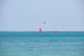 People sportsmen windsurfing and kite surfing in blue ocean water. Summer extreme exotic sport concept Royalty Free Stock Photo