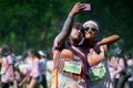 People are spotted during The Color Run street race and having fun Marathon, Bright color paint all over a large crowd.