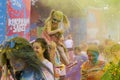 People sprinkled with colored powder at a colorful race