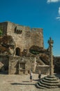 People on square with pillory in front of stone castle Royalty Free Stock Photo