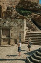 People on square with pillory in front of stone castle Royalty Free Stock Photo