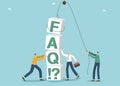 People stack cubes with letters FAQ