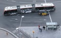 People stand on a bus stop in Barcelona