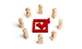 People stand in a circle and look at the red check mark in the box. election, poll or referendum. Poll people. Voters participate Royalty Free Stock Photo