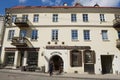 People stand in front of a souvenir shop in the historical town of Vilnius, Lithuania.