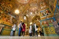 People stand inside the Cathedral with magical paints and fresco.