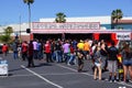 People stand in line at the Official Merchandise booth in parking lot