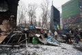 People stand near the burned barricades after nigh