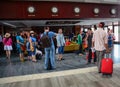 People stand near registration counter