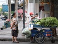 People stand next to a mobile food cart