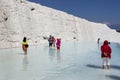 People stand in one of the thermal pools at the travertines, or Cotton Castle, at Pamukkale in Turkey.