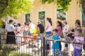 People stand in queue at the zoo. Street