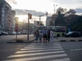 People stand on the road in front of a traffic light. Road traffic. The family crosses the road. Streets of Batumi. Red traffic