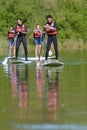 people on stand up paddle board paddeling Royalty Free Stock Photo