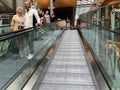 People keeping the safe distance in the escalators of the shopping center