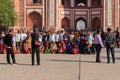 People in front of the main gateway of Taj Mahal