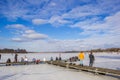 People standing on the jetty of the frozen lake in Paterswolde