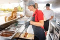 People standing in line in front of food truck