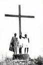People standing next to the large cross at the top of Mount Gemi near Amedzofe, Ghana c.1958