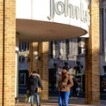 People Standing Outside A Large John Lewis Department Store