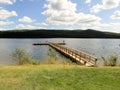 People standing on a pier in the lake at Lac Le Jeune provincial park, BC, Canada.