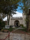 People standing in queue line at the entrance to Topkapi Palace. Two towers and stone wall. Royalty Free Stock Photo