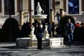 People standing by a fountain in a sunny morning in Seville