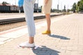 People standing on taped floor markings for social distance at train station, closeup. Coronavirus pandemic