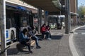 People at the station wait for the bus with a medical mask due to corona virus