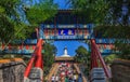 People on the steps leading to Bai Ta (White Pagoda or Dagoba) s Royalty Free Stock Photo