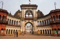 People stopped past historic indian gates with arches in ancient city