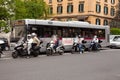 People stopped in traffic on scooters