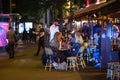 People at a street restaurant at night in Paris